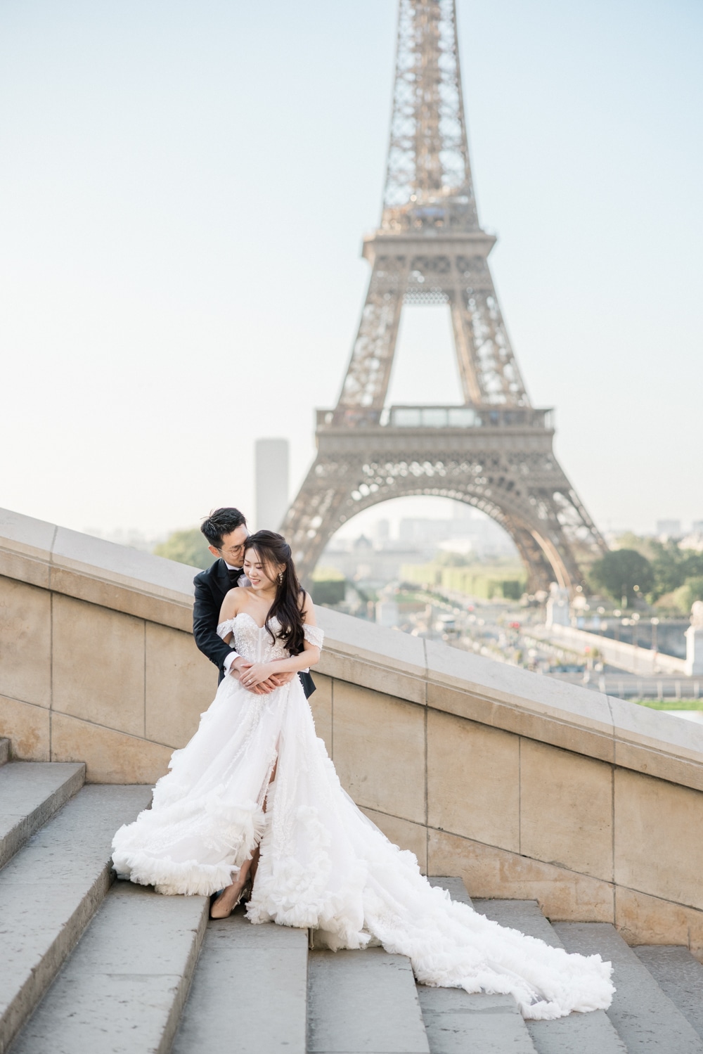 Couple posing in front of the Eiffel Tower during a Paris Love Session