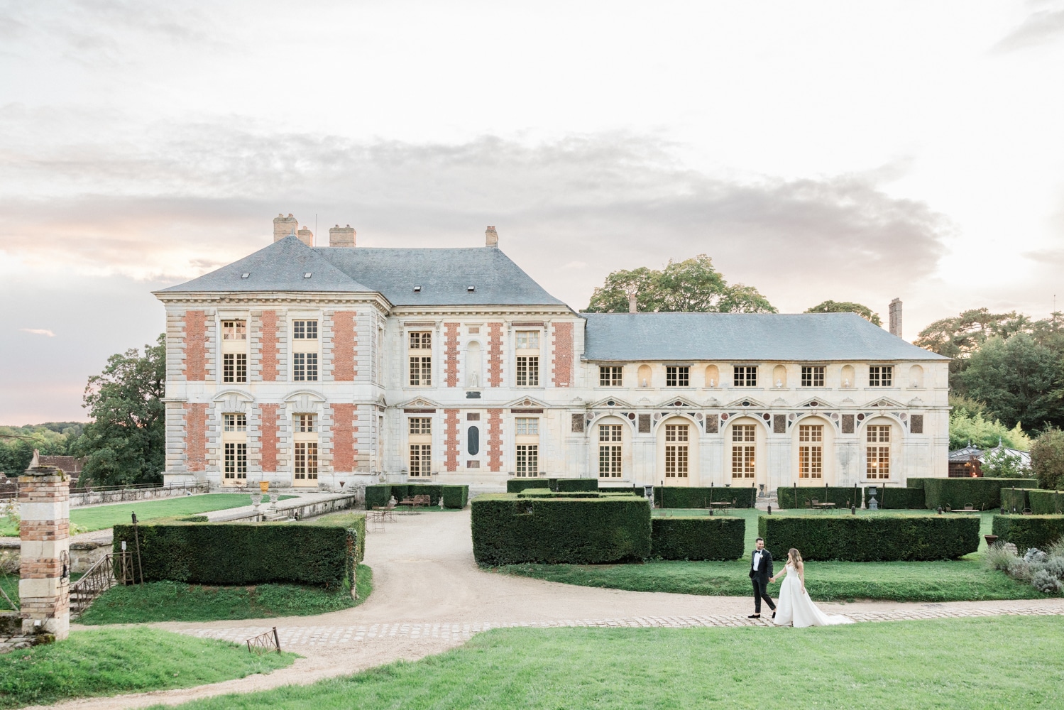 Bride and groom in front of the historic Château de Vallery