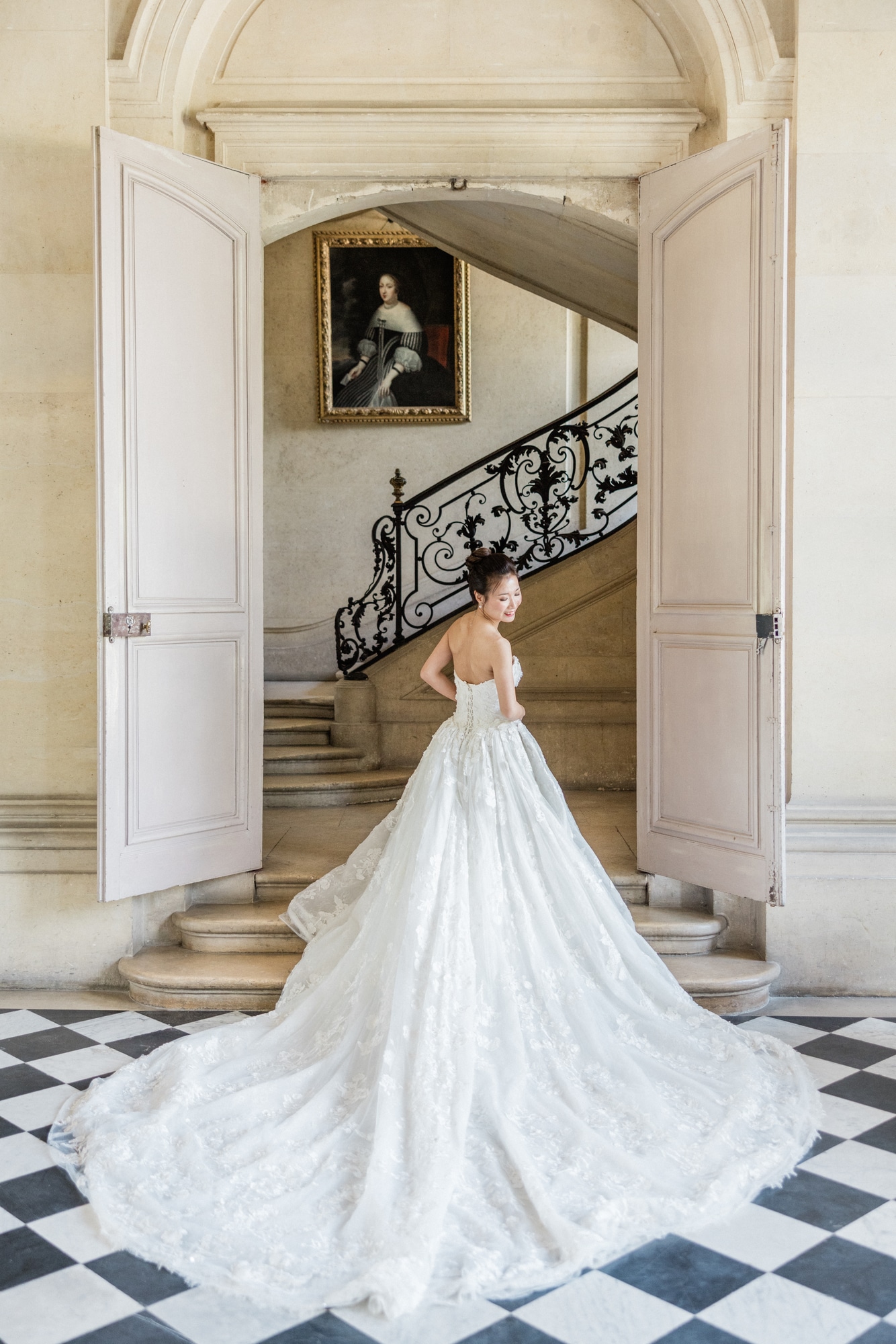 Beautiful bride playing with her gown at the Chateau de Champlatreux