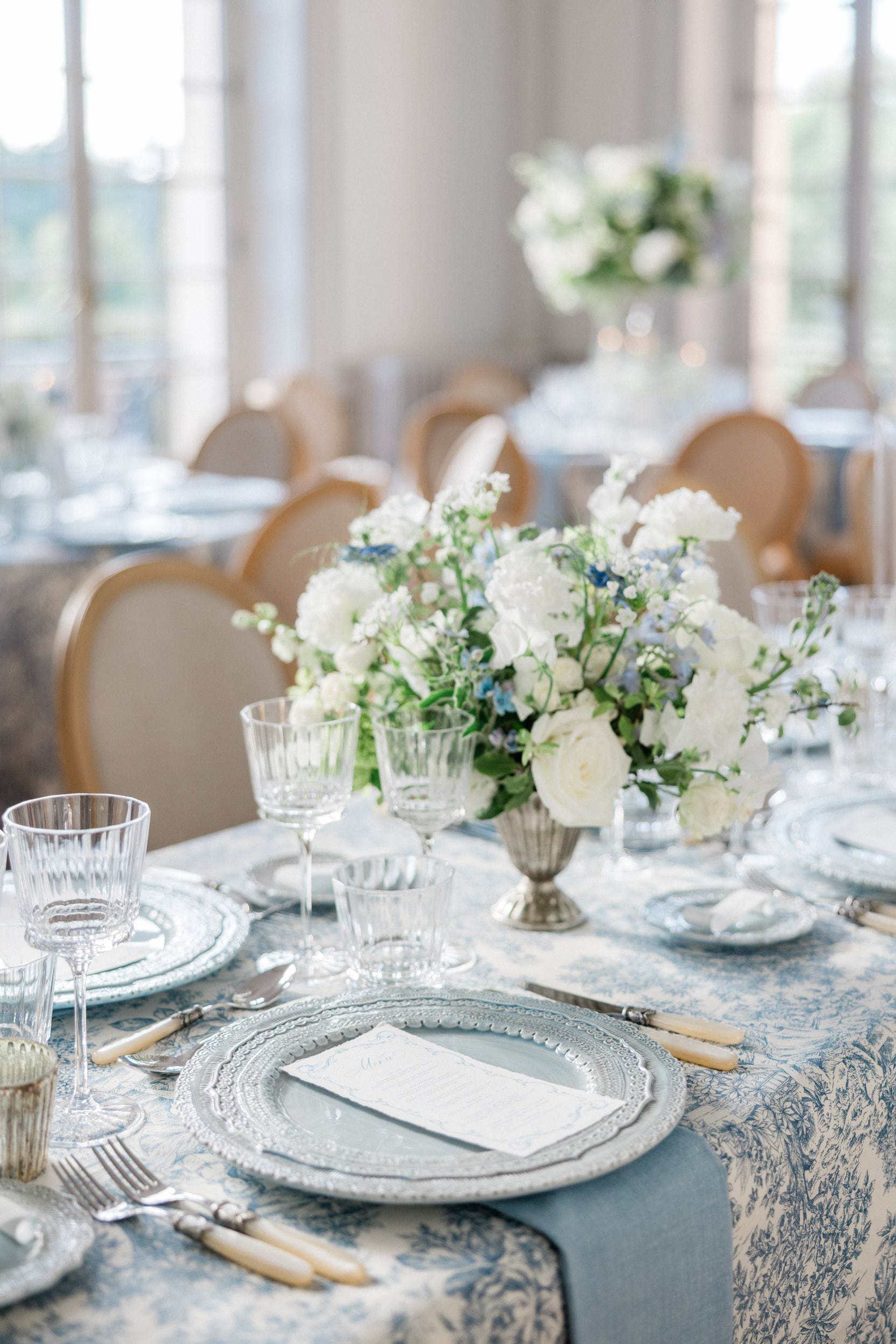 Elegant château wedding reception photographed in a refined blue and sage palette