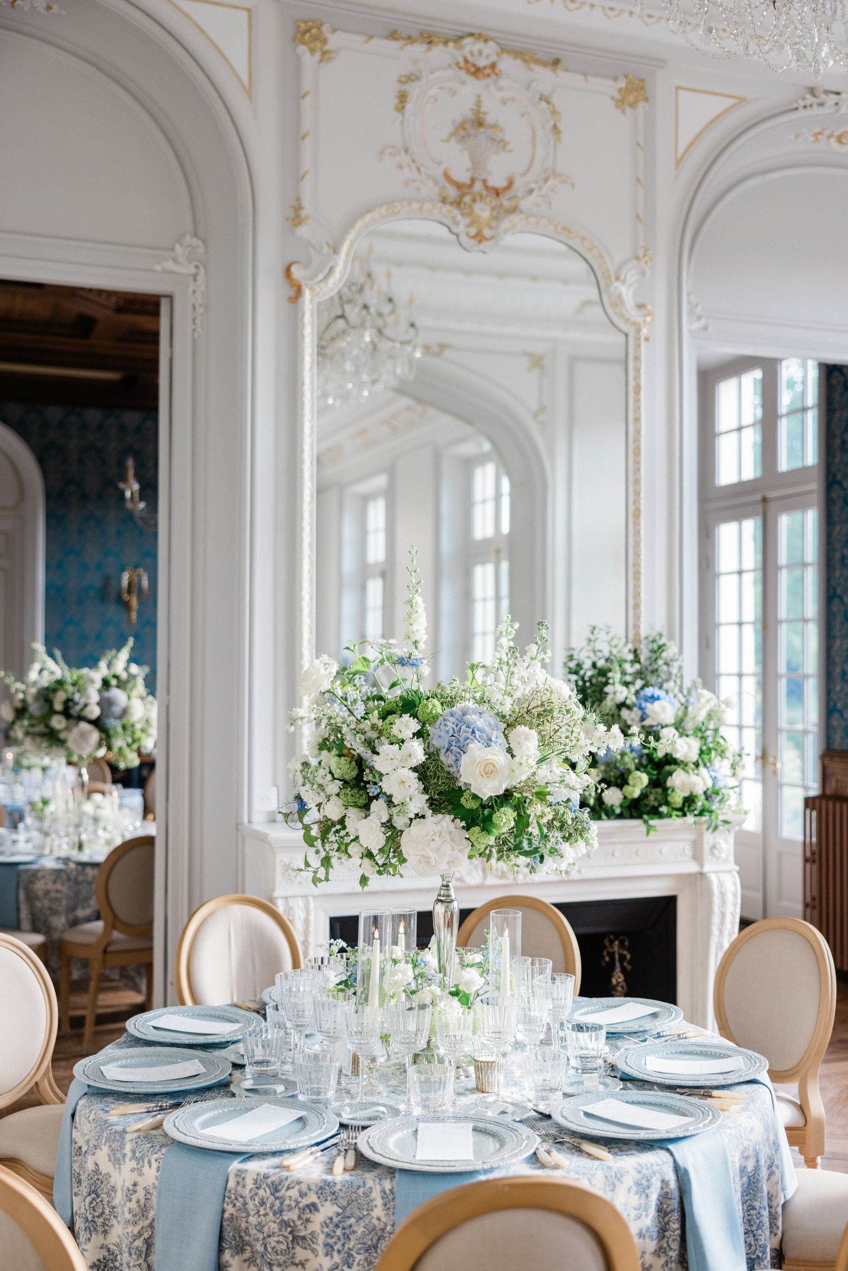 Elegant blue, sage and gold dinner setting at a French château