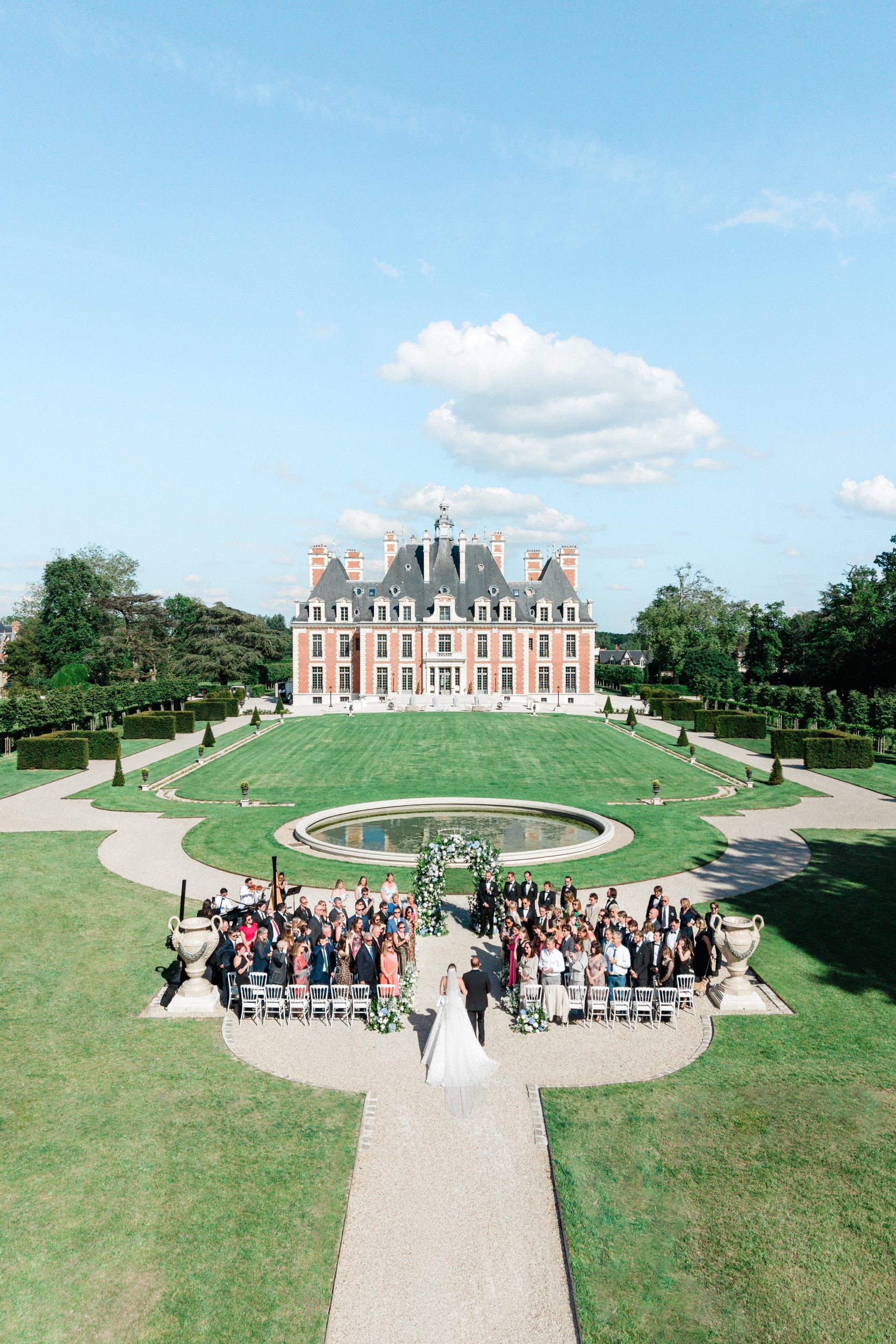 Bride walking down the aisle during her wedding ceremony at Château de Nainville-les-Roches