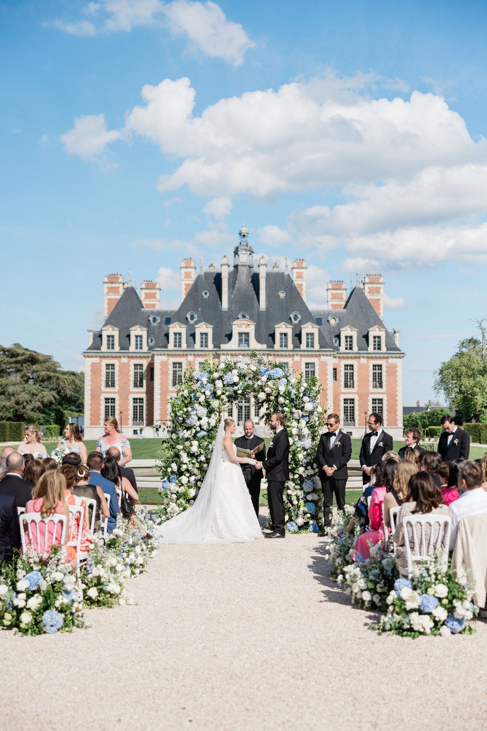 Bride and groom holding hands during their wedding ceremony