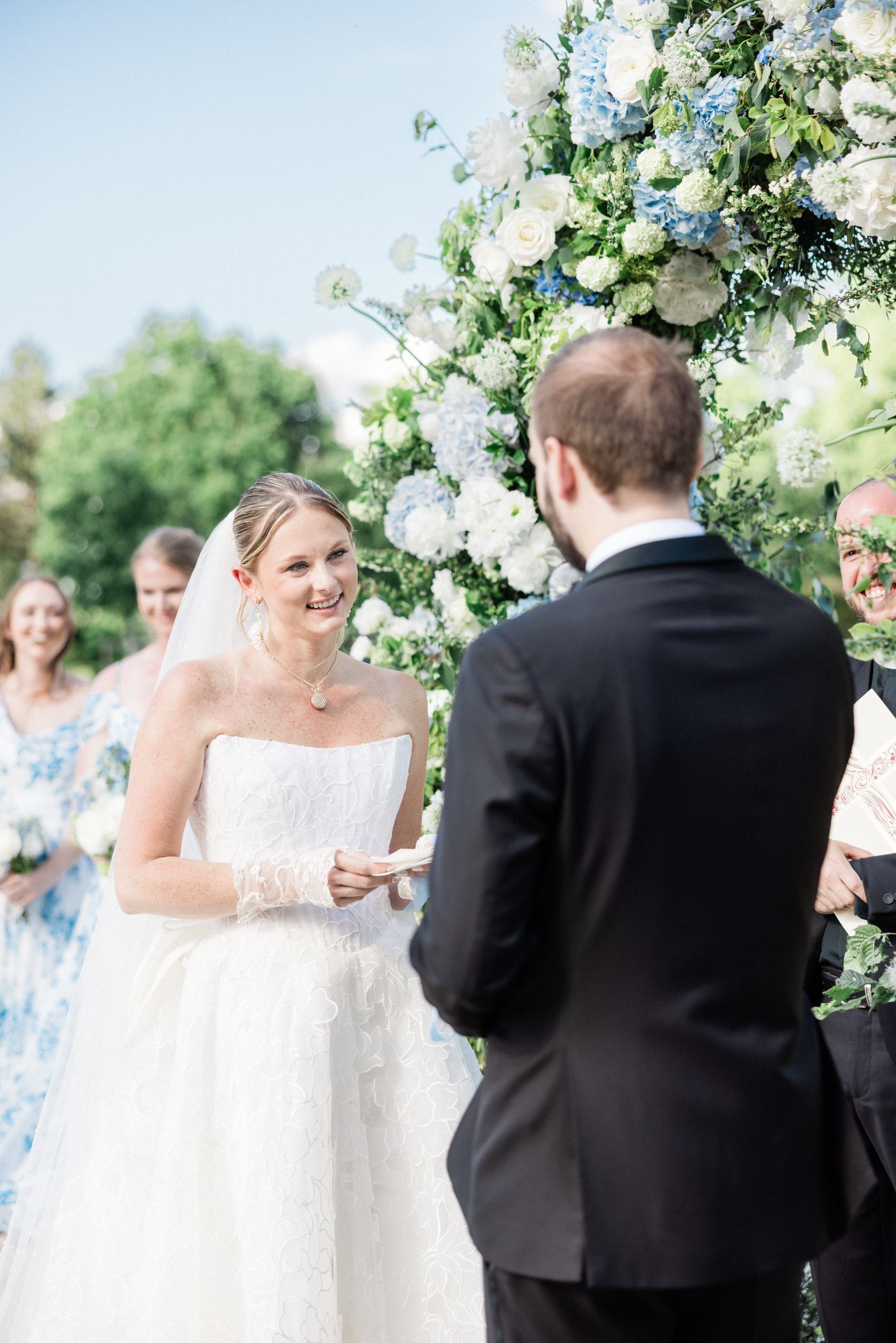 Bride smiling at the groom during their wedding ceremony