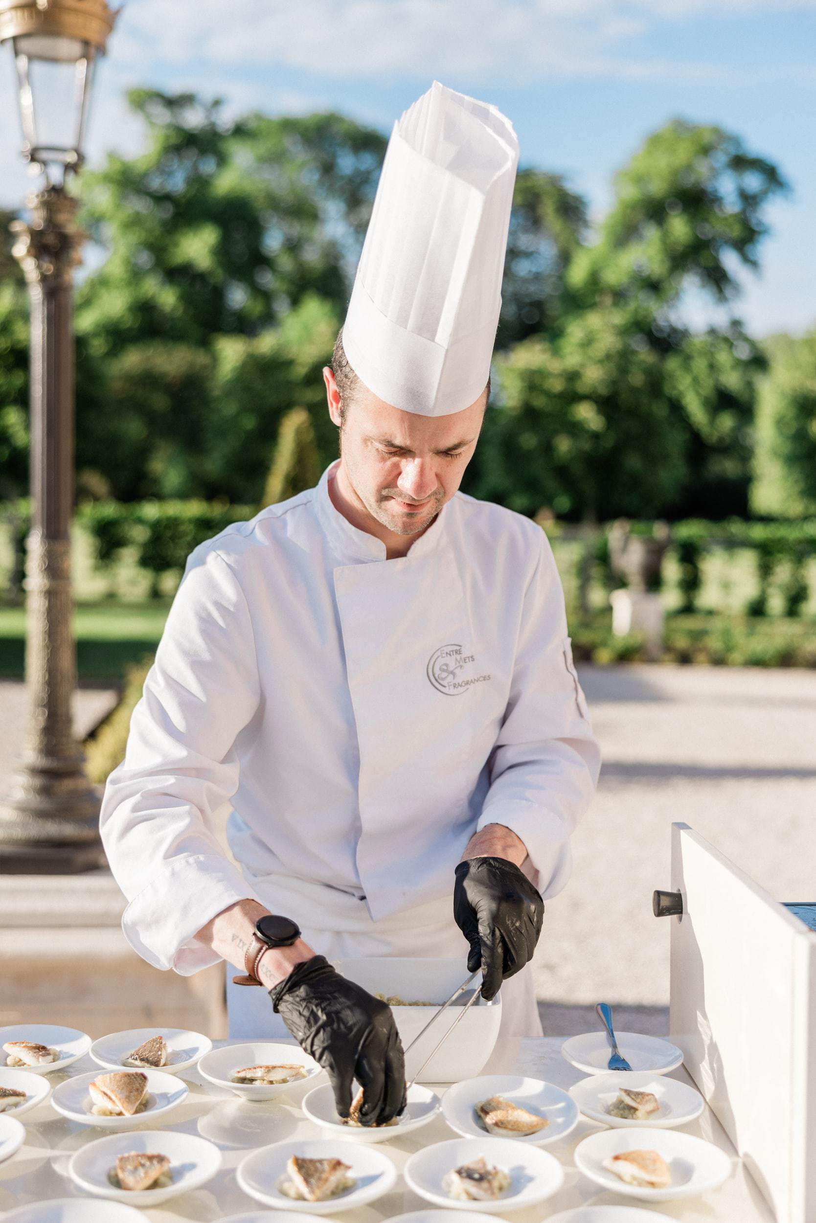 French chef preparing food at an elegant château wedding in France