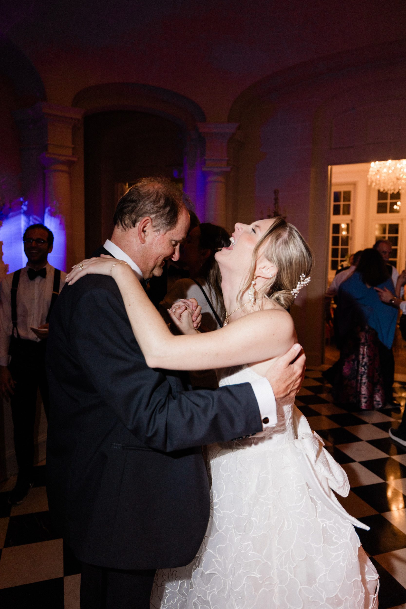 Bride and her father sharing an emotional moment at a French château wedding